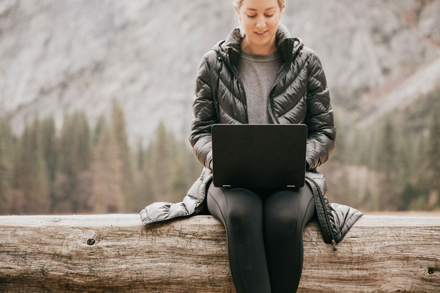 woman using laptop in nature